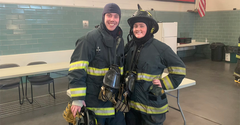 Young male and young femaie dressed in the fire fighting gear