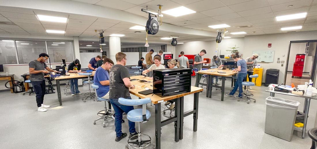 Design-Shop Students work at various stations across the bright design shop.