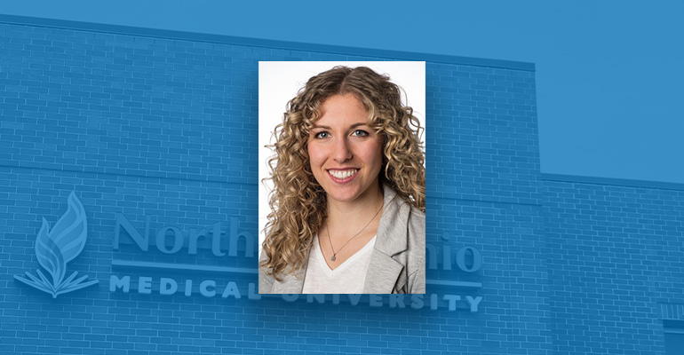 Kailey Christman headshot on blue backdrop