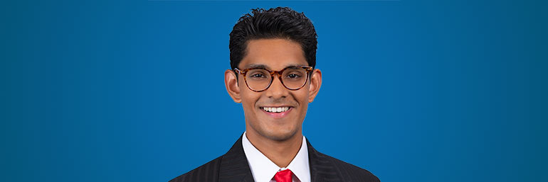 Sanjay Jinka against a blue background.