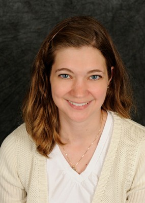 Sara Dugan headshot - dark backdrop