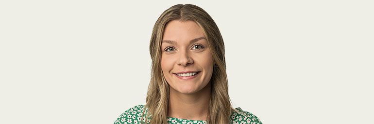 Paige Tulcewicz, a 2023 graduate of NEOMED, against a tan background.