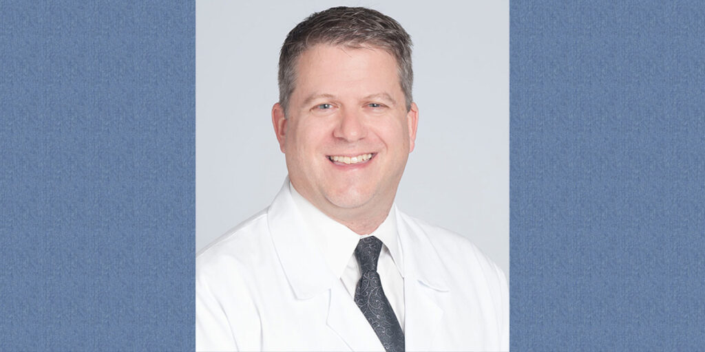 Headshot of Richard Wardrop MD on a light blue backdrop
