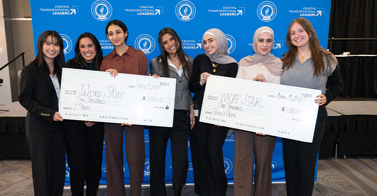 Group of young women hold two oversized checks payable to "Wrap Star"
