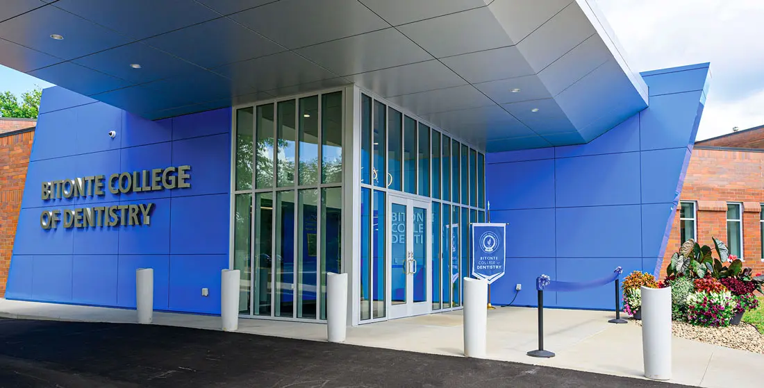 The main entrance to the Bitonte College of Dentistry on a summer afternoon.