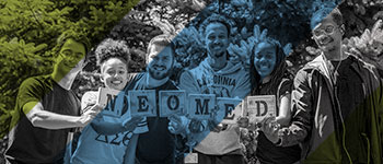 A group of NEOMED students hold letters spelling out the name of the University.