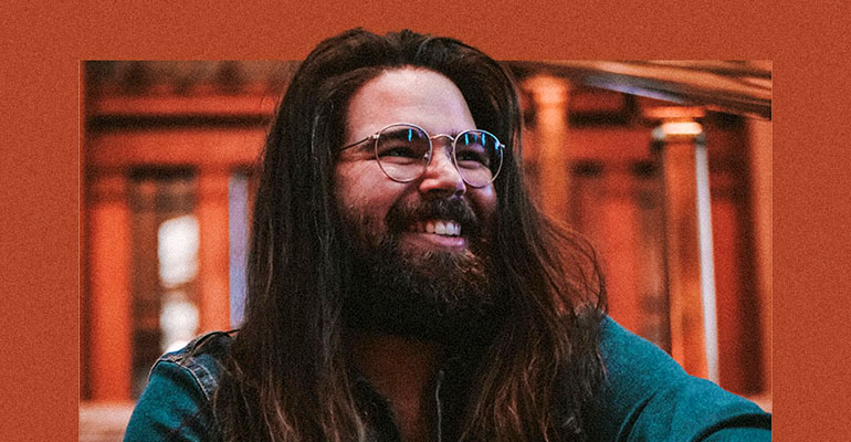 Schizophrenia advocate and social media influencer Nathan Shuherk in a library.