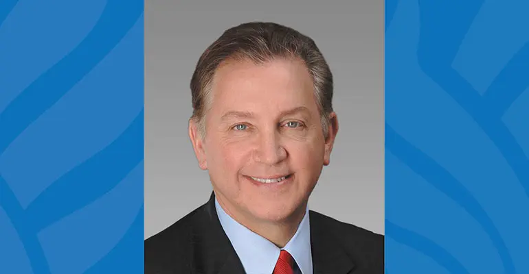 Dr. Frank Papay, the university's commencement speaker, in a coat and tie.