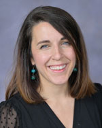 A portrait of a smiling woman.