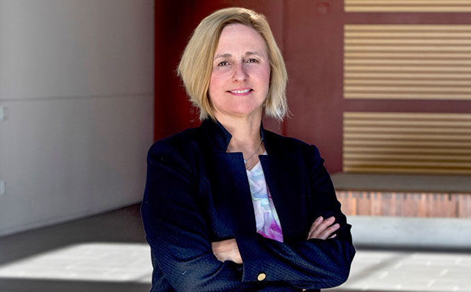 A woman with her hands crossed.